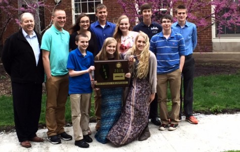 Adviser Steve Steele, left, and his Taylorville journalism students display their IHSA sectional team championship plaque after tying Urbana University High for first place at the Normal Illinois State University sectional in 2015. Students will compete at seven other sectional locations for the chance to qualify for the IHSA state final at Eastern Illinois University in Charleston for 2016.