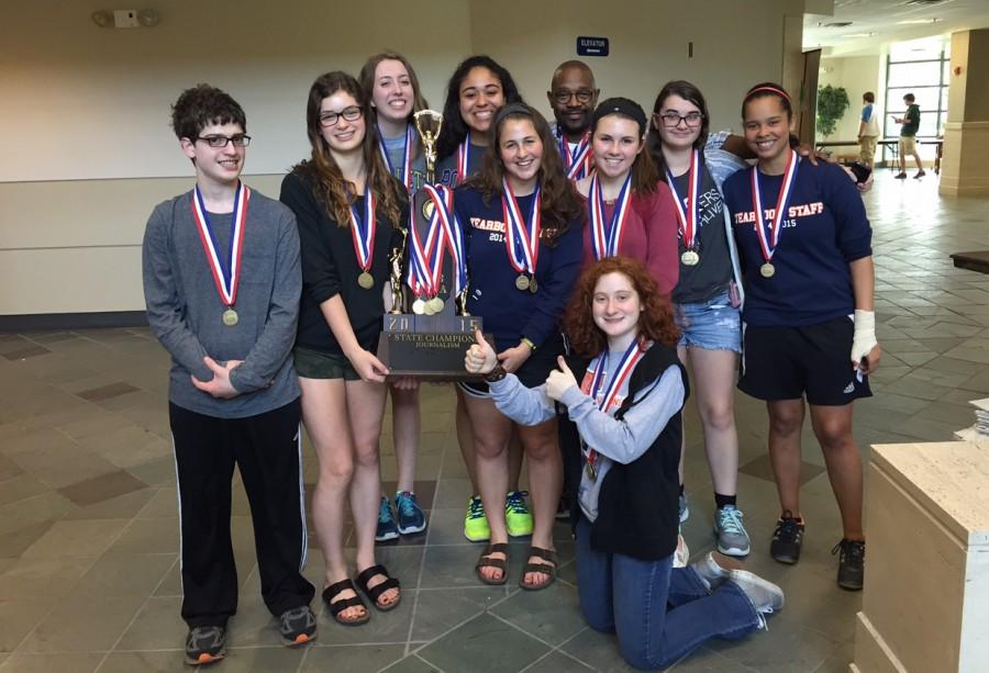 Adviser Rodney Lowe (back row, fourth from right) and his Evanston Township students enjoy victory at the IHSA journalism state final Friday in Charleston.